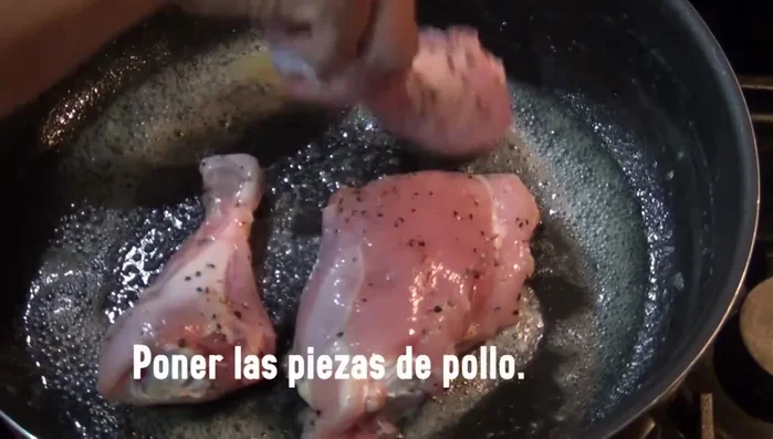 Brown the chicken pieces in the saucepan.