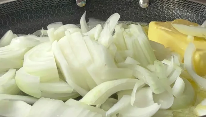 Add 2 chopped yellow onions to the butter sauce.