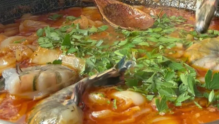 Add the shelled and deveined black tiger shrimp. Simmer until pink.