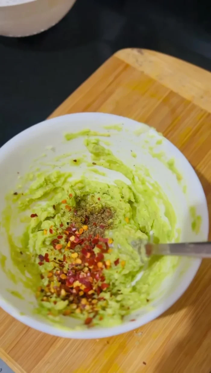 Add chili flakes and oregano flakes.