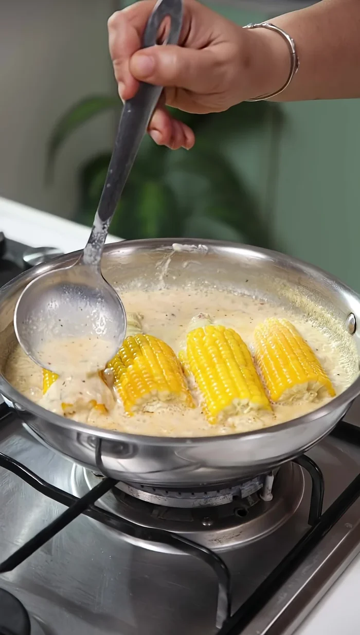 Add the steamed corn to the sauce and cook for 4-5 minutes, ensuring the flavors are absorbed.