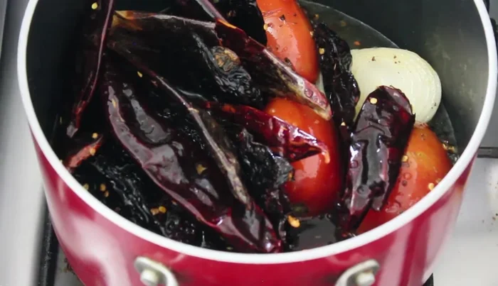 Add the fried chilies back to the pot with water. Bring to a boil until all ingredients are hydrated.