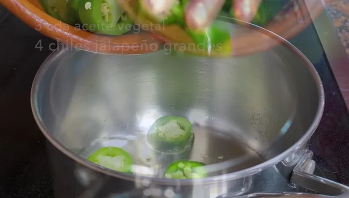 Prepare the jalapeño sauce: In a saucepan, sauté jalapeño peppers, garlic, and onion in hot oil until softened. Add a little water to help cook the chilies. Lower the heat, cover, and cook for 8-10 minutes.