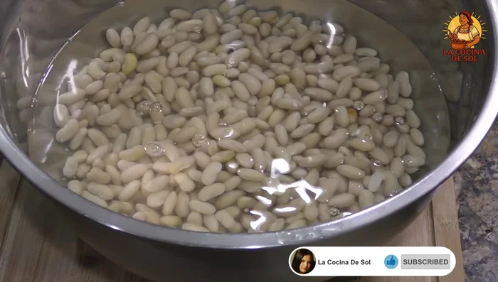Soak beans in water for 3 hours or overnight. Cook beans in a pressure cooker with a piece of onion and 1 teaspoon of salt for 35 minutes.