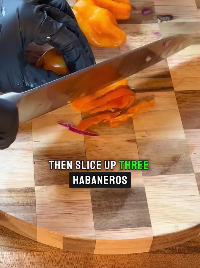 Slice three serrano peppers. Leave the seeds in for extra heat.