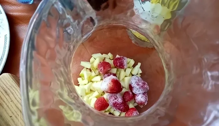 Add the frozen strawberries to the pitcher.