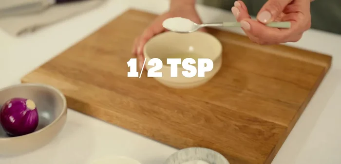 Part the lime and mix its juice with sugar, water, and a pinch of salt in a small bowl.