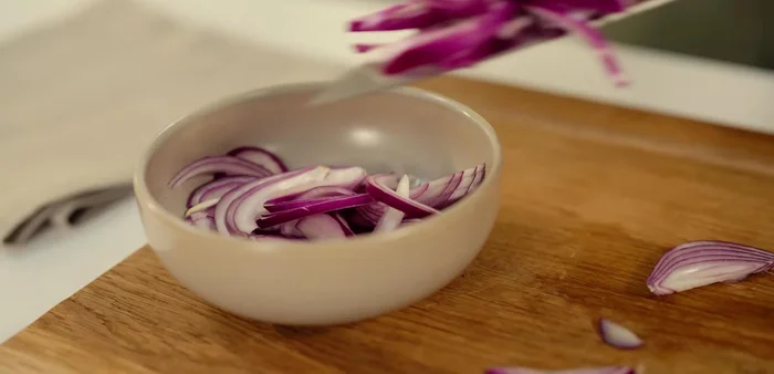 Thinly slice the red onion, add to a bowl, pour over the pickling mixture, and set aside.