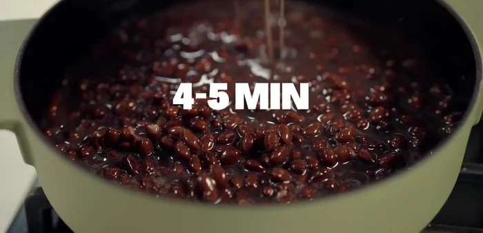 Heat a saucepan and cook the black beans with their liquid. Add vegetable stock, Mexican spice, and season with salt and pepper. Mash until smooth and keep warm.