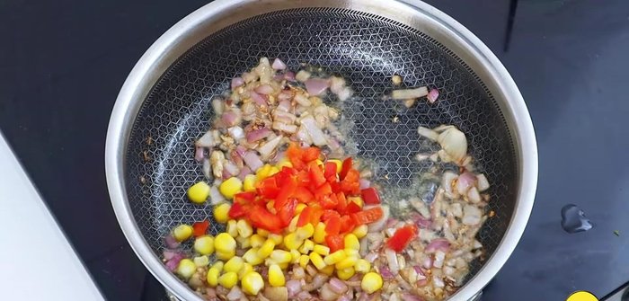 Add corn, capsicum, and sauté on medium-low flame.