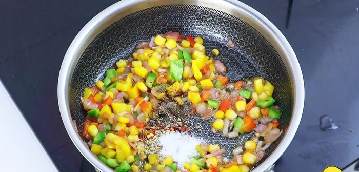 Add chili flakes, oregano, black pepper, salt, and Kashmiri red chili powder. Mix well.