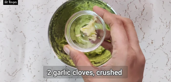 Crush two garlic cloves and mix them with the mashed avocado.