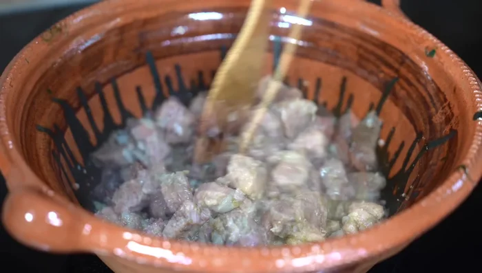 Add the molcajete mixture to the meat. After a couple of minutes, add the sauce and let simmer until tender.