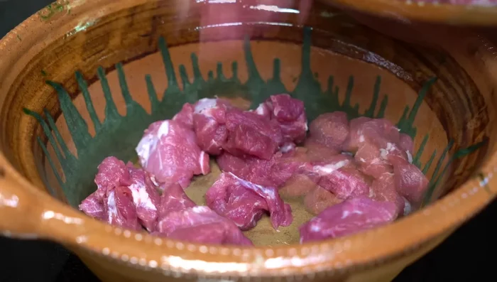 Place meat in a casserole dish. Add a little water and cook until the meat releases its own fat.
