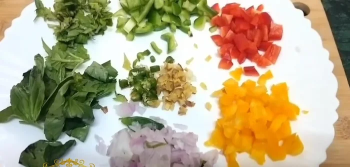 Chop vegetables: bell peppers, garlic, ginger, green chilies, basil, and coriander.