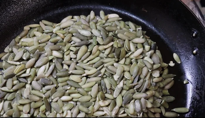 Toast 250g green pepitas on a griddle until fragrant. Toast 1/4 cup peanuts in the same pan.