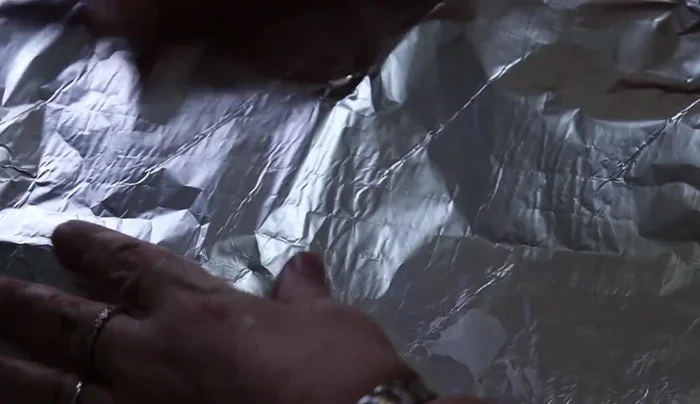Cover the mold tightly with aluminum foil.