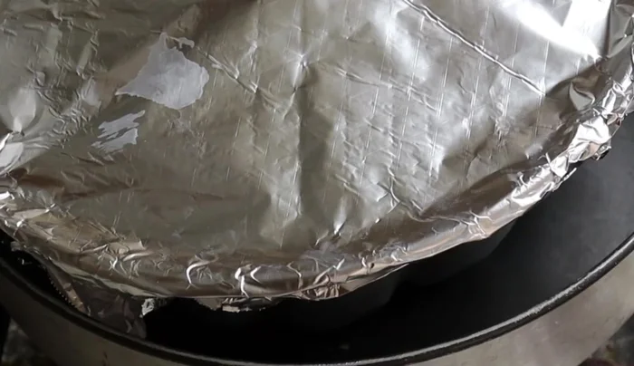 Preheat oven to 200°C (392°F). Place the covered mold in a double boiler (larger mold with hot water). The water should reach the middle of the smaller mold, ensuring it doesn't boil over.