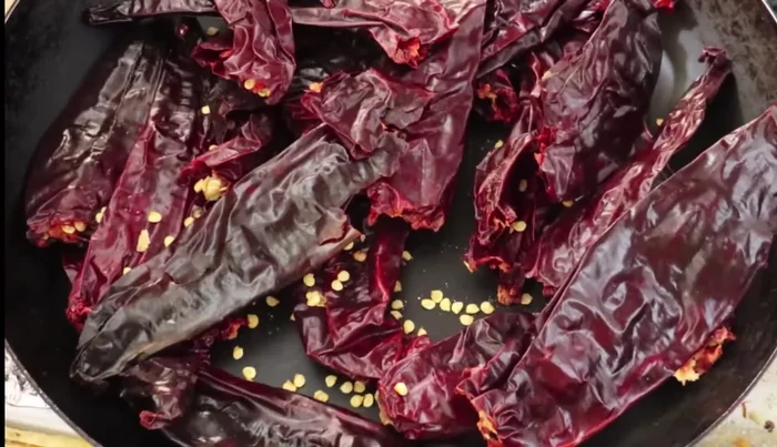 Roast the guajillo chiles until they change color slightly. Avoid burning.