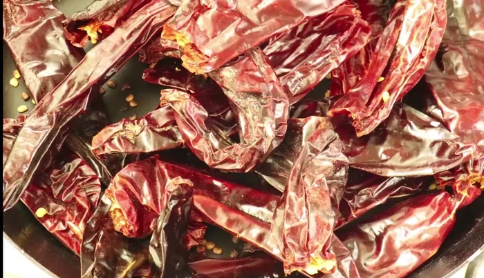 Soak the roasted chiles in hot water for a few minutes.