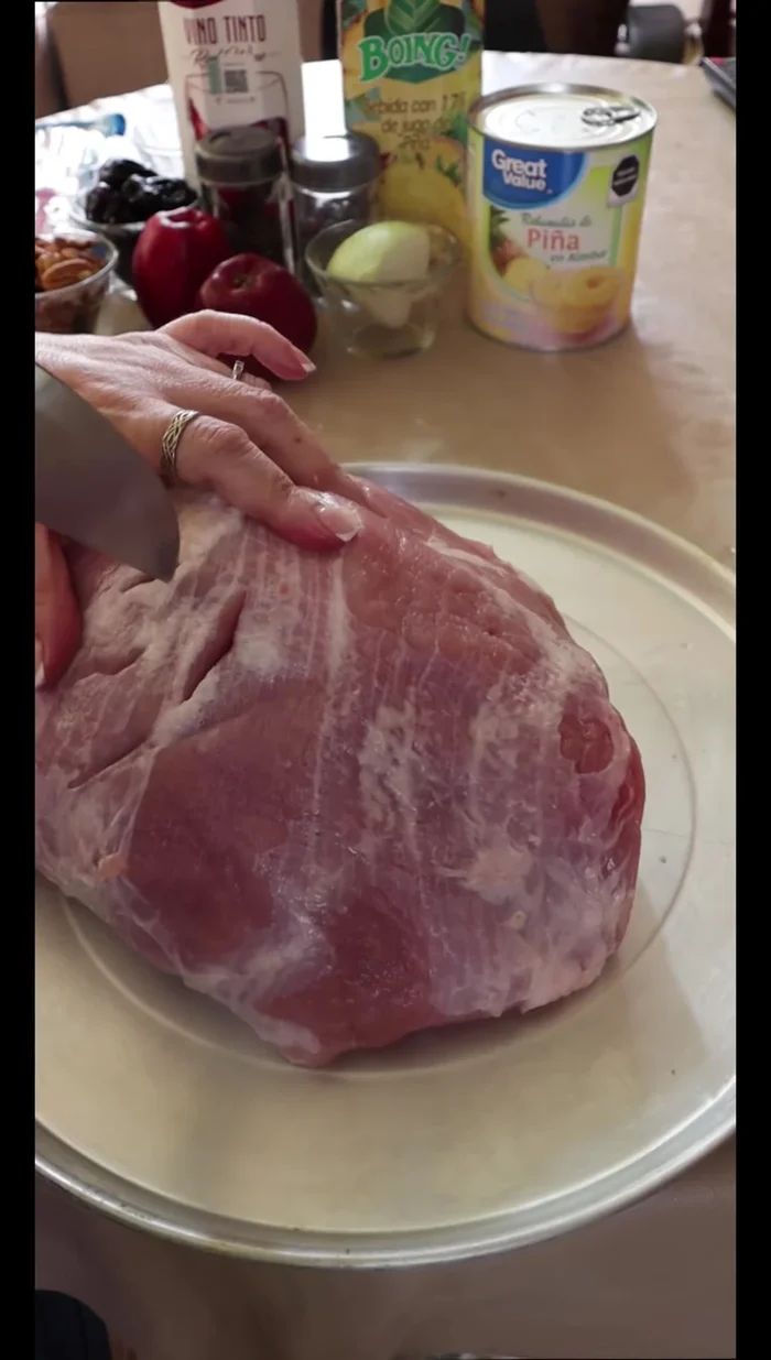 Make holes in the leg of lamb using a knife or butcher's tools.