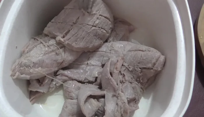 Chop the cooked suadero into small pieces.