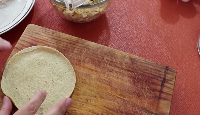 Warm the tortillas and fill each with the cooked chicken.
