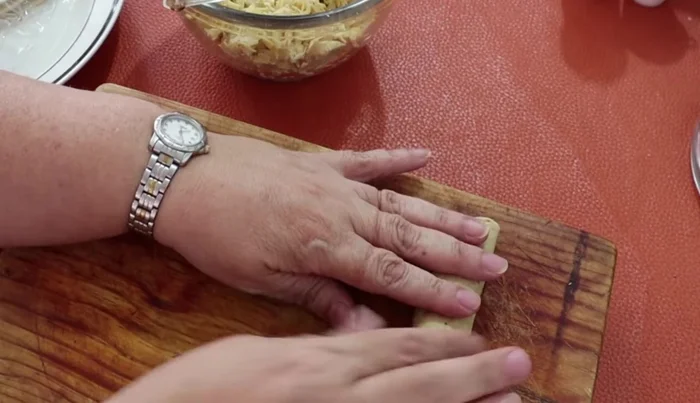 Roll up the filled tortillas to form flautas (taquitos).