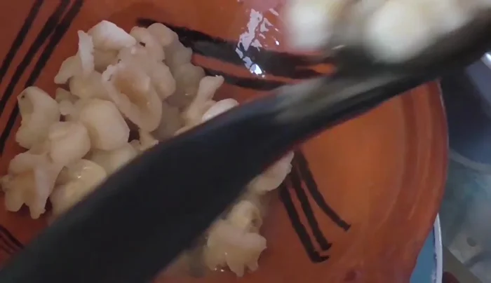 Serve: Ladle the pozole into bowls. Add corn, meat (including head), and broth. Garnish to taste with lemon, onion, oregano, chili piquín, sardines (optional), avocado, and pork rinds.