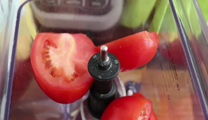 Blend 4 halved tomatoes, 1/4 chopped onion, and water in a blender.