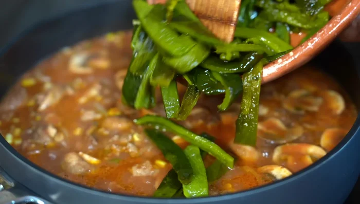 Add poblano pepper strips and cook for another 10 minutes until softened.