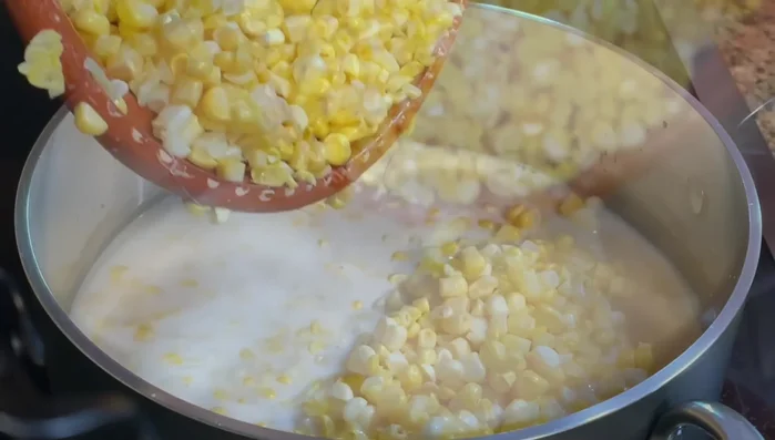 Add the corn kernels and cob pieces to the saucepan. Bring to a boil, then reduce heat and simmer for 10-15 minutes, stirring frequently.