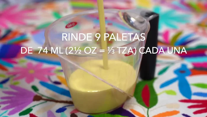 Pour the mixture into popsicle molds, adding a few kernels of corn to some of the molds before filling to the top.