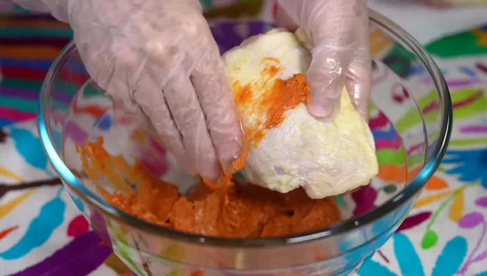Season the chicken: Spread most of the butter mixture all over the chicken thighs, lifting the skin to ensure even flavor distribution.