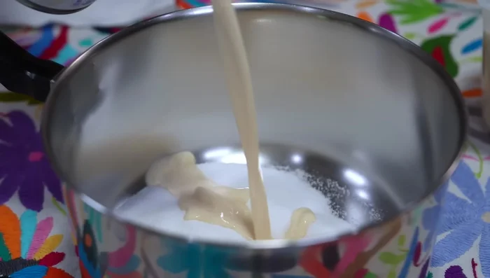 In a saucepan, combine sugar, evaporated milk, and milk. Stir until sugar dissolves.