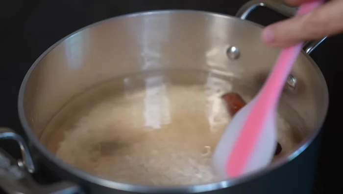 Add the rinsed rice to the cinnamon mixture. Reduce heat to medium-low and cook, stirring occasionally to prevent sticking, for 15 minutes, or until most of the water is absorbed.