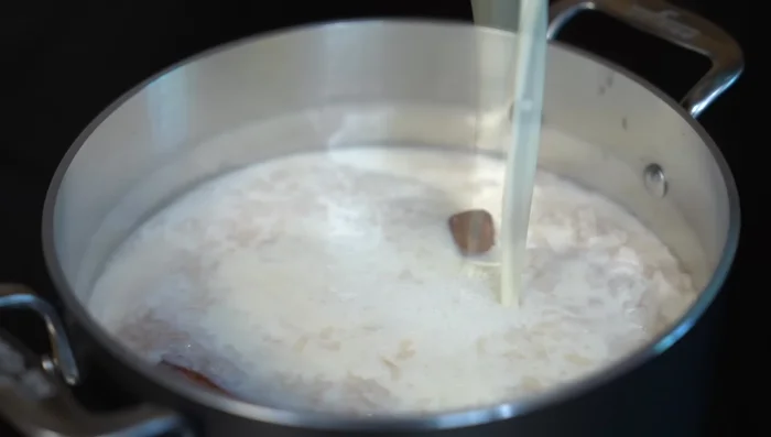 Add the warmed milk mixture to the rice. Cook over medium heat for 15 minutes, stirring occasionally. Reduce heat and cook for another 15 minutes.
