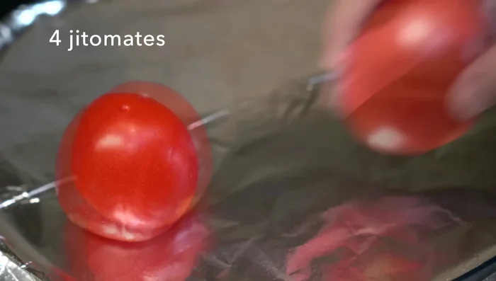 Prepare the roasted red salsa: Roast tomatoes, garlic, onion, and serrano peppers on a hot griddle until softened. Blend with salt.
