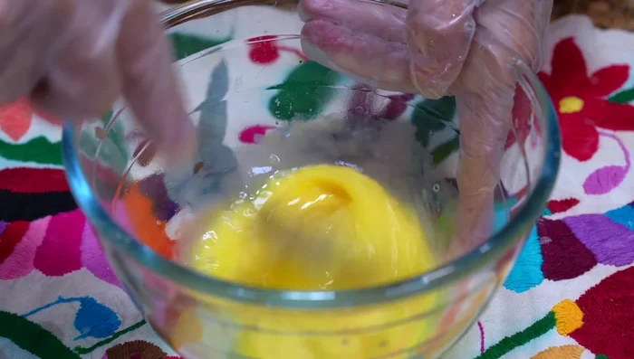 In a bowl, beat an egg with the potato starch. Mix with the grated potatoes, onion, cheese, salt, and pepper. Add more egg and cornstarch/flour as needed to achieve desired consistency.