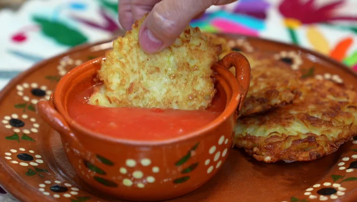 Serve the potato pancakes with the spicy red sauce.