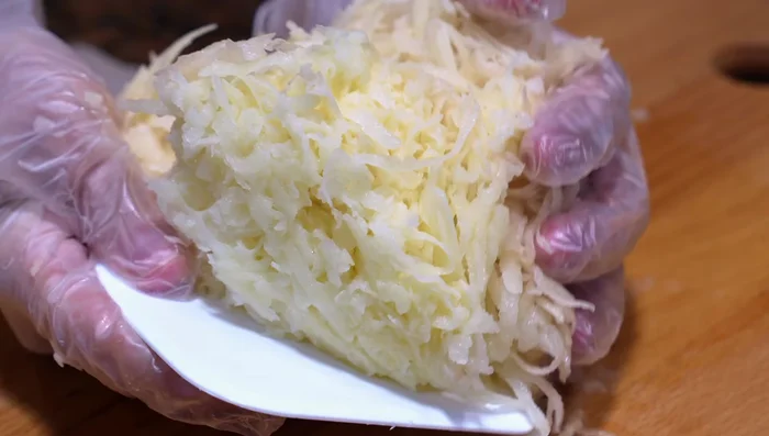 Wrap the grated potatoes in a kitchen towel and squeeze out excess liquid. This helps make them crispier.