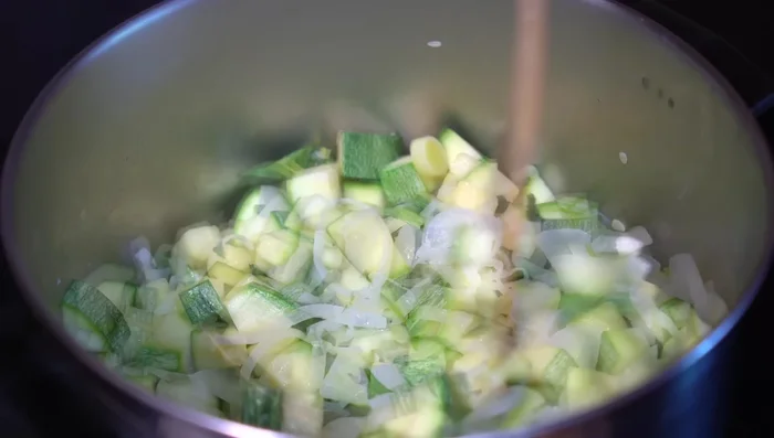 Add hot chicken broth (or water). Cover and simmer until zucchini is very soft (18-20 minutes).