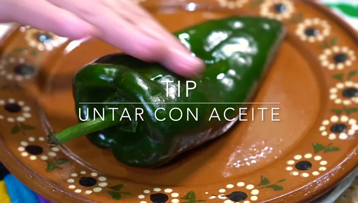 Roast poblano peppers, then peel and cut into strips. Slice the onion thinly.