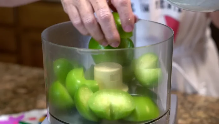 Make avocado salsa by blending green tomatoes, serrano peppers, cilantro, salt, and avocado.