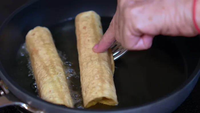 Fry tacos until golden brown on both sides.