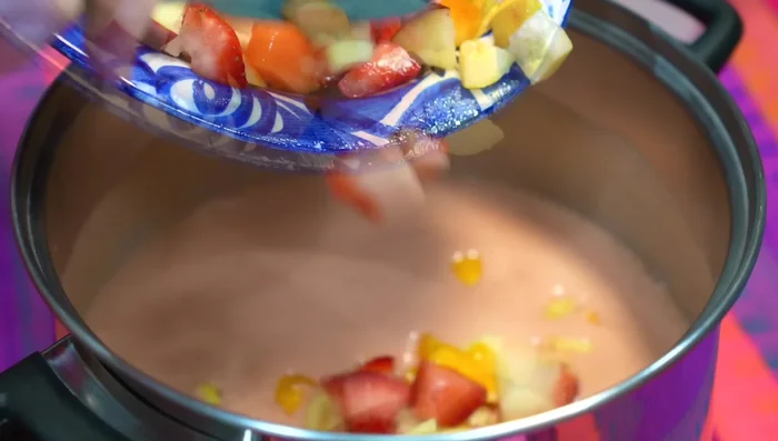 Add chopped garnish fruits (mango, strawberries, apple, melon, guava).