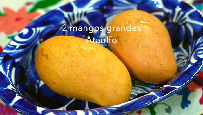 Prepare mangoes: blend the pulp of 1.5 mangoes, chop the remaining half for garnish.