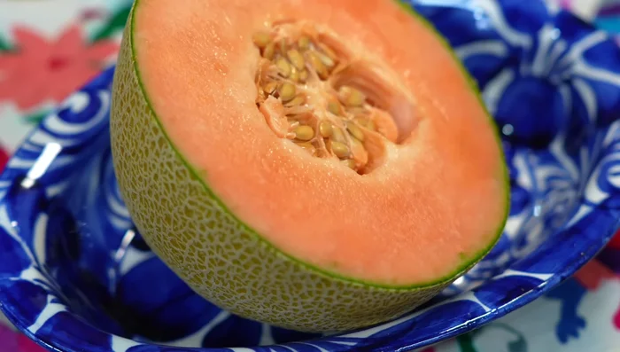 Prepare cantaloupe: use half for blending, chop the other half for garnish.