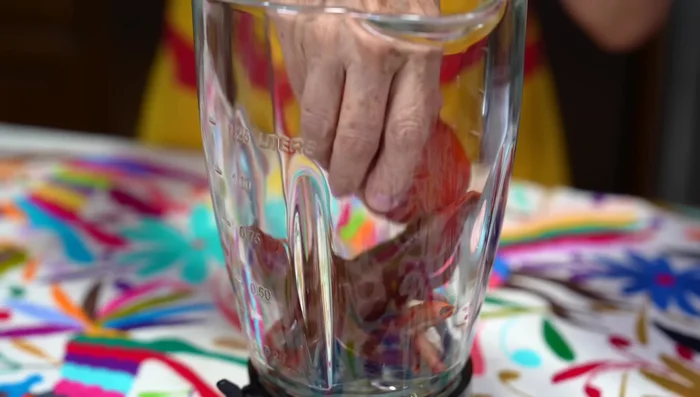 Blend the cooked chilies, tomatoes, and cooking water until smooth. Strain and reserve.