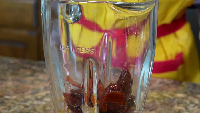 Blend the cooked chiles, achiote powder, salt, spices, and extra vinegar until smooth.